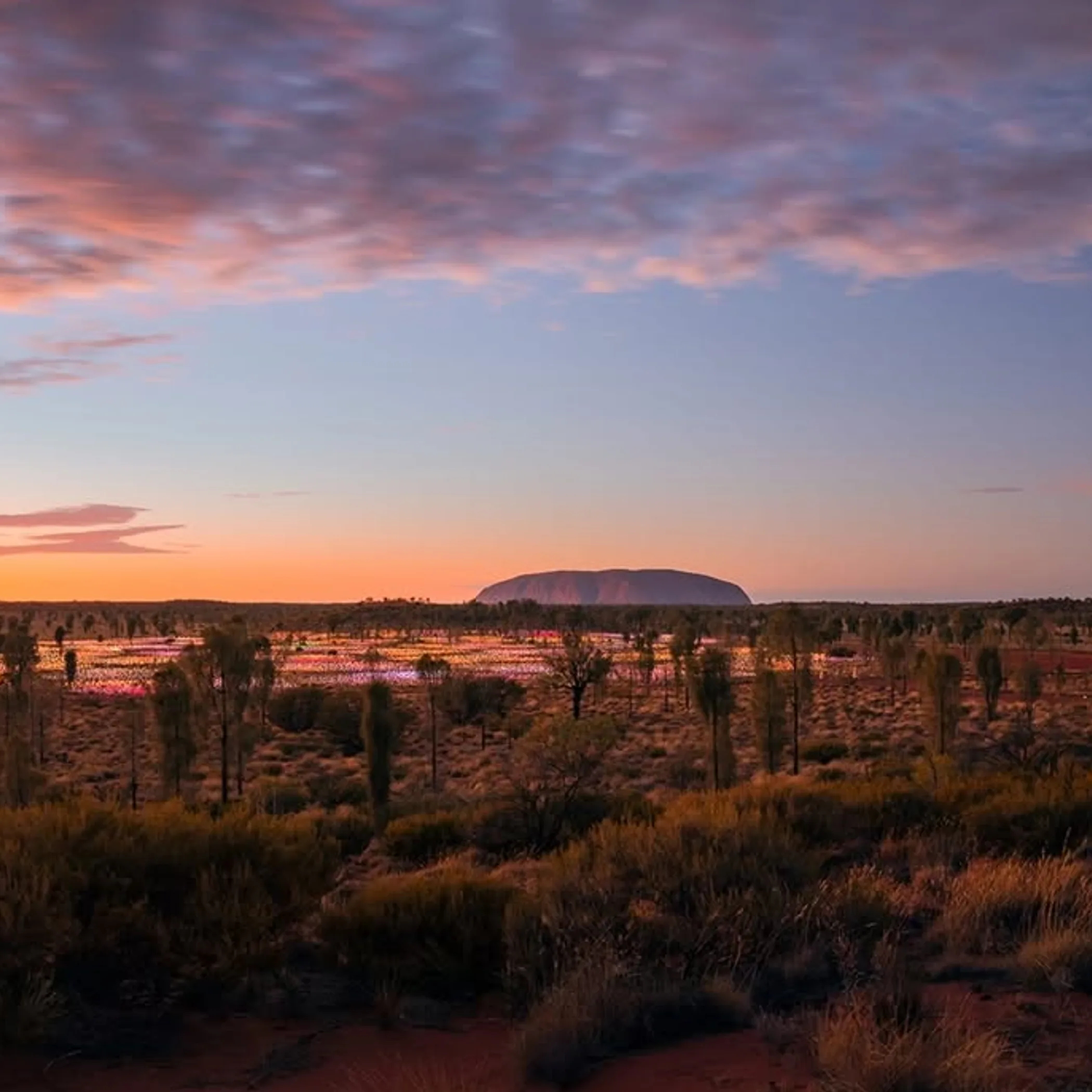 uluru surrounded by red desert